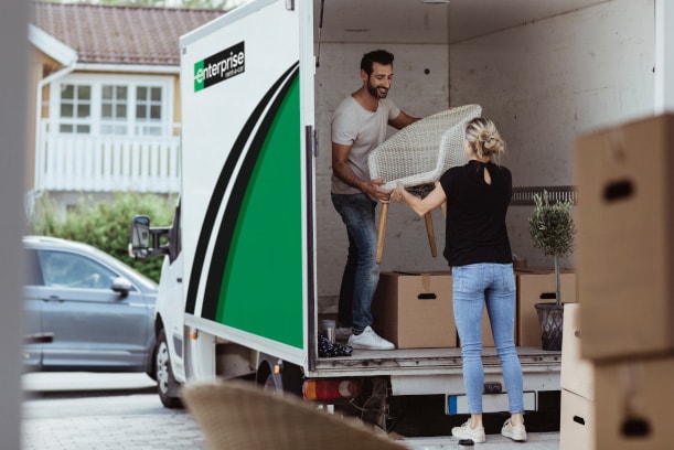 couple moving boxes into new home